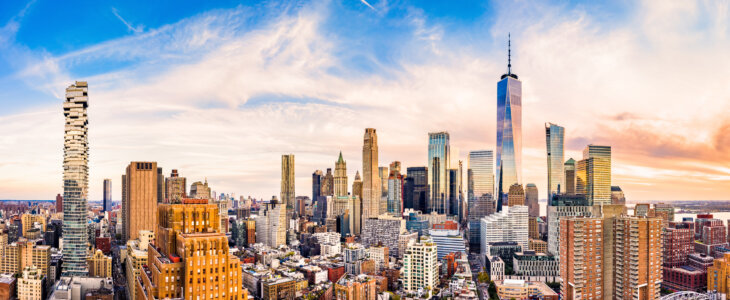 Aerial panorama of Lower Manhattan skyline at sunset viewed from above Greenwich street in Tribeca neighborhood.