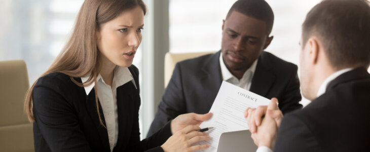 Angry dissatisfied businesswoman holding contract arguing with contractor, pointing at terms failed to perform, demanding termination, loss compensation, defrauded cheated investor protecting rights